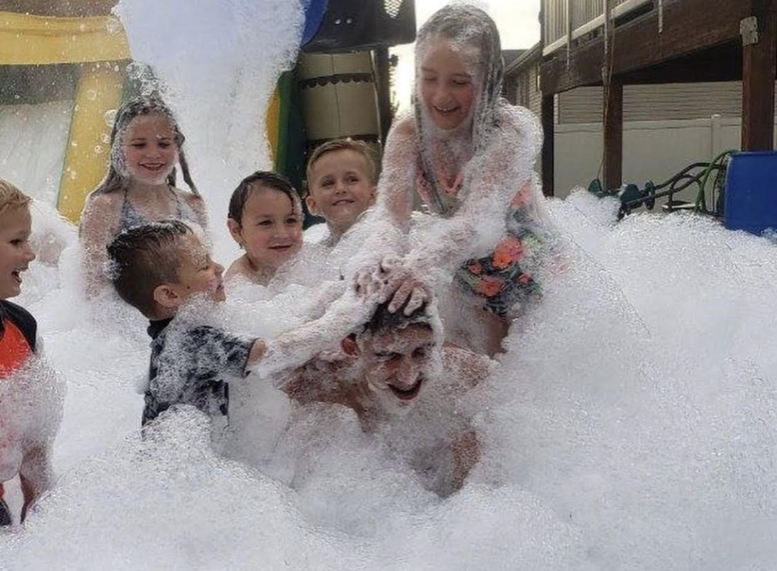 Kids running around at a foam party near me.